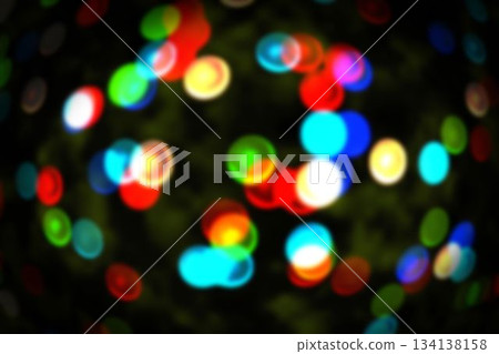 Cluster of defocused colored light circles is floating in bokeh effect over dark backdrop Cluster of defocused colored light circles is floating in bokeh effect over dark backdrop 134138158