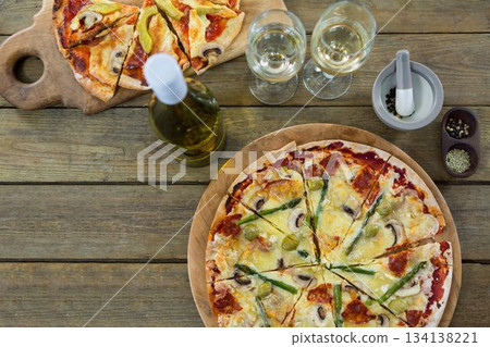 Pizza with white wine served on wooden table Pizza with white wine served on wooden table 134138221
