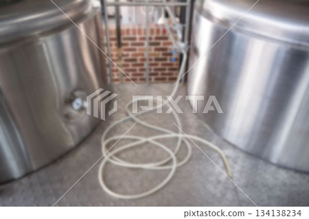 Defocused image of hose by storage tank at brewery factory Defocused image of hose by storage tank at brewery factory 134138234