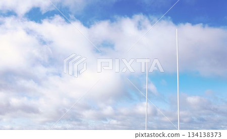 Two white sports goal posts are standing under wide partly cloudy sky in flat vector illustration Two white sports goal posts are standing under wide partly cloudy sky in flat vector illustration 134138373