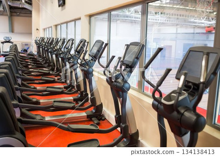 Cross trainers arranged at gym Cross trainers arranged at gym 134138413