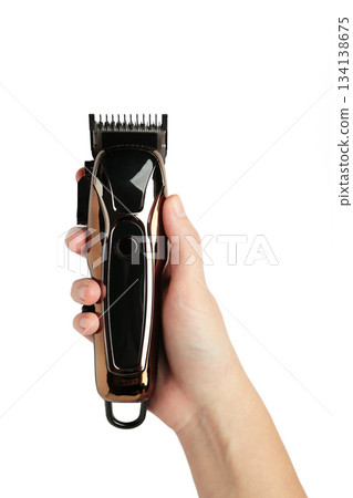 Hair clipper in hand isolated on white background. Modern hair clipper. Hair clipper in hand isolated on white background. Modern hair clipper. 134138675
