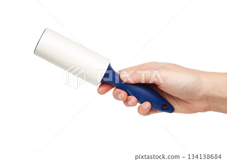Woman holding lint roller isolated on white background. Top view Woman holding lint roller isolated on white background. Top view 134138684