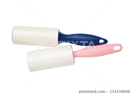 Cloth fabrics cleaner lint roller brush with paper roll isolated on white background. Sticky roller, pet cat dog fur dust hair remover Cloth fabrics cleaner lint roller brush with paper roll isolated on white background. Sticky roller, pet cat dog fur dust hair remover 134138698