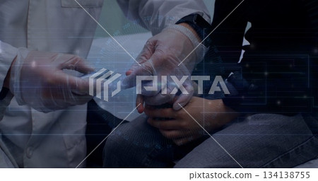 Performing finger-prick test doctor in lab coat steadying patient in exam room, with lancing pen 134138755