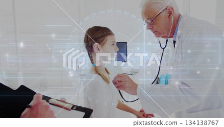 Listening senior physician examining girl's chest in medical clinic, with stethoscope and clipboard 134138767