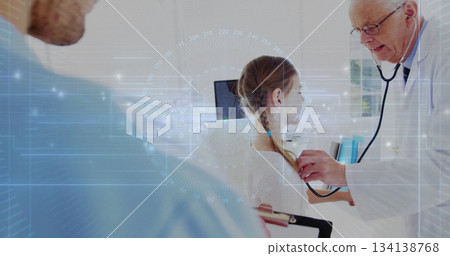 Listening physician using stethoscope on girl at exam table in clinic with clipboard and monitor Listening physician using stethoscope on girl at exam table in clinic with clipboard and monitor 134138768