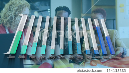 Reviewing three coworkers discussing materials around table in office, with bar chart overlay 134138883