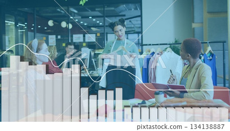 Designer holding garment sample in modern office lounge, with hanger and clothing rack 134138887