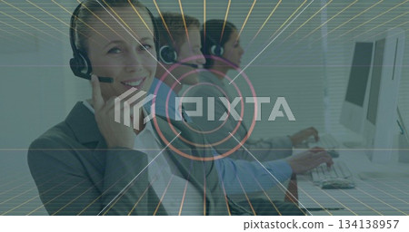 Typing businesswoman wearing blazer and headset working at call center with monitors, copy space 134138957