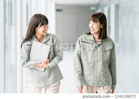 Female staff in the manufacturing, building, transportation, and construction industries wearing work clothes. 134139073