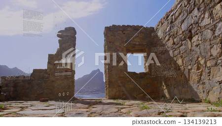 Framing crumbling stone wall showing ruins on coastal ledge featuring window opening and sea view Framing crumbling stone wall showing ruins on coastal ledge featuring window opening and sea view 134139213