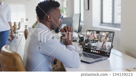 Attending African American man in blue shirt joining meeting on laptop at open office, copy space 134139223