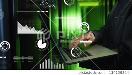 Standing mature Korean IT engineer holding laptop in data center aisle, with overlays, copy space Standing mature Korean IT engineer holding laptop in data center aisle, with overlays, copy space 134139234