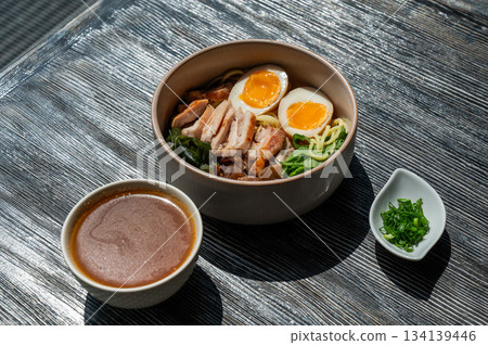 Ramen soup in a cafe. Broth separately. Ramen soup in a cafe. Broth separately. 134139446
