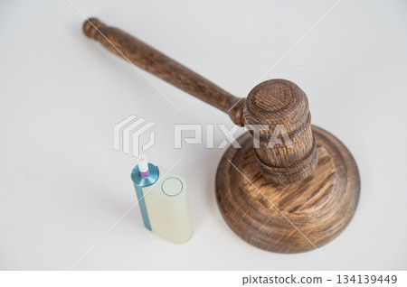 Judge's gavel and electronic cigarette. Smoking ban. Tobacco heating systems.  134139449