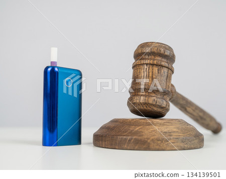 Judge's gavel and electronic cigarette. Smoking ban. Tobacco heating systems. Judge's gavel and electronic cigarette. Smoking ban. Tobacco heating systems. 134139501