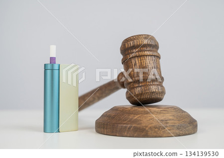 Judge's gavel and electronic cigarette. Smoking ban. Tobacco heating systems.  134139530