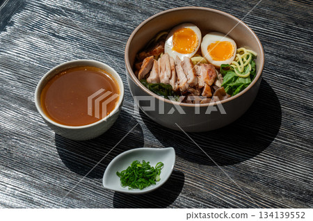 Ramen soup in a cafe. Broth separately. Ramen soup in a cafe. Broth separately. 134139552