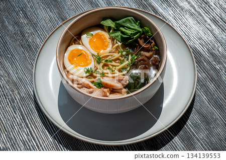 Ramen soup in cafe on wooden table. Ramen soup in cafe on wooden table. 134139553