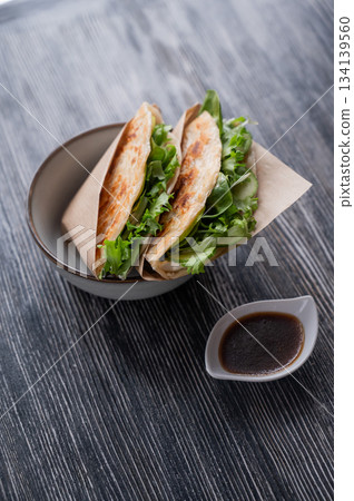 Flatbread with greens served in a cafe. Flatbread with greens served in a cafe. 134139560