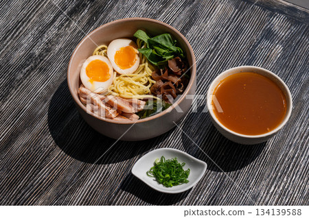 Ramen soup in a cafe. Broth separately. Ramen soup in a cafe. Broth separately. 134139588