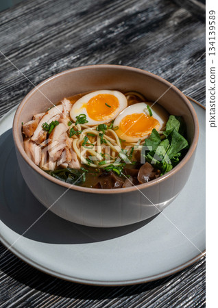Ramen soup in cafe on wooden table. Ramen soup in cafe on wooden table. 134139589