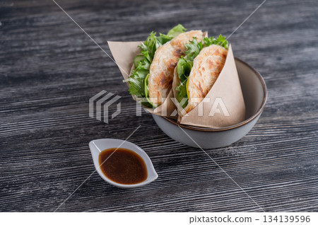 Flatbread with greens served in a cafe. Flatbread with greens served in a cafe. 134139596