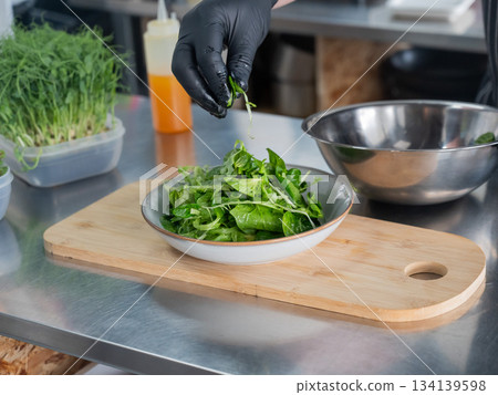 The chef prepares a salad. The chef prepares a salad. 134139598