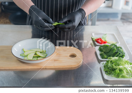 The chef lays out the salad. The chef lays out the salad. 134139599