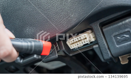 Woman using OBD2 diagnostic scanner.  134139695