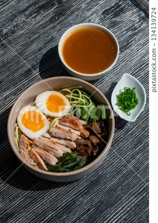 Ramen soup in a cafe. Broth separately.  134139724