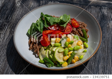 Top view of a dish of buckwheat noodles with vegetables. Top view of a dish of buckwheat noodles with vegetables. 134139751
