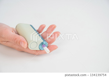 Woman holding electronic cigarette on white background. Tobacco heating systems. 134139754