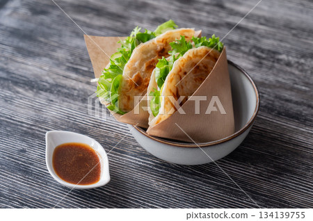 Flatbread with greens served in a cafe. Flatbread with greens served in a cafe. 134139755