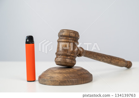 Judge's gavel hits disposable vape. Smoking ban. 134139763