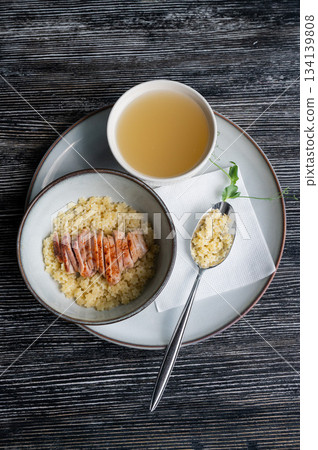 Chicken broth with noodles on a wooden table. Chicken broth with noodles on a wooden table. 134139808