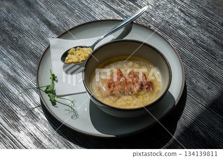 Chicken broth with noodles on a wooden table. Chicken broth with noodles on a wooden table. 134139811
