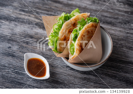 Flatbread with greens served in a cafe. Flatbread with greens served in a cafe. 134139928