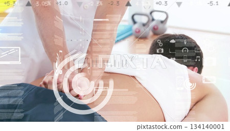 Female therapist pressing down on client back in spa room, with kettlebells and data overlay Female therapist pressing down on client back in spa room, with kettlebells and data overlay 134140001