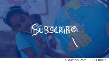 Pointing female student leaning toward large globe on desk in classroom, bulletin board, copy space 134140064