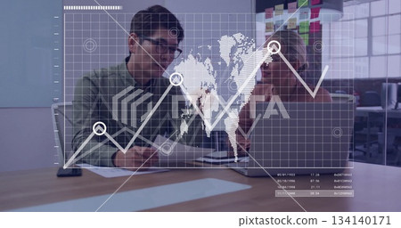 Coworkers in business attire reviewing documents in open office, with laptop pen sticky notes board 134140171