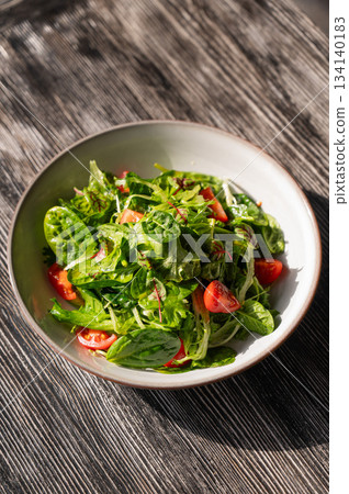 Green salad served in a cafe. Green salad served in a cafe. 134140183