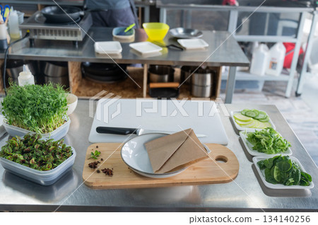 Making a flatbread with herbs in a cafe. Making a flatbread with herbs in a cafe. 134140256