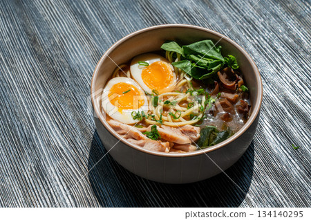Ramen soup in cafe on wooden table.  134140295