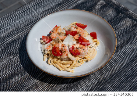 Pasta with shrimp and tomatoes.  134140305