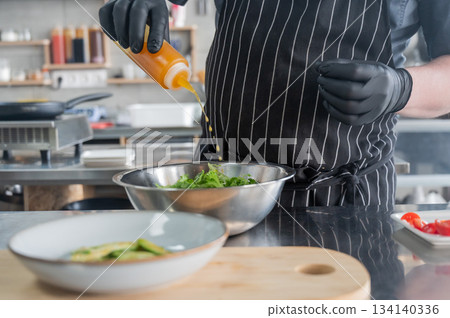The chef prepares a salad. The chef prepares a salad. 134140336
