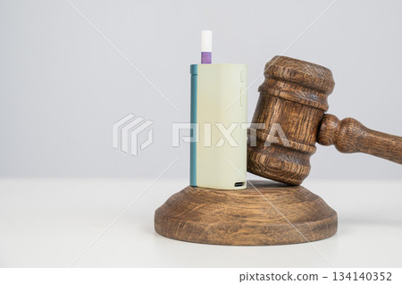 Judge's gavel and e-cigarette. Smoking ban. Tobacco heating systems.  134140352