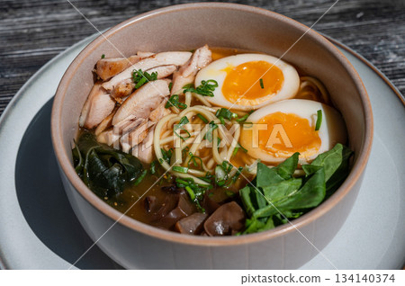 Ramen soup in cafe on wooden table. Ramen soup in cafe on wooden table. 134140374