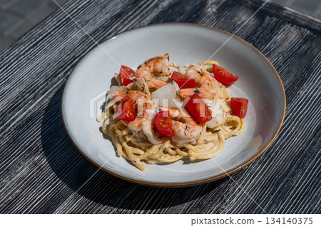 Pasta with shrimp and tomatoes.  134140375